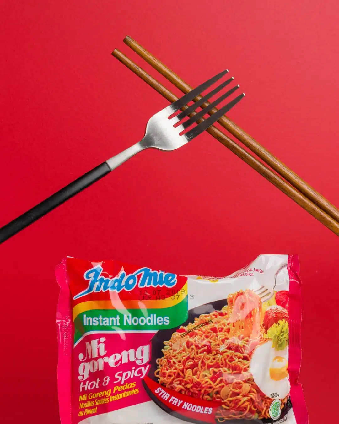 a fork and a bag of Indomie instant noodles