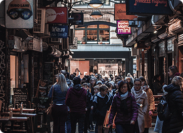 a crowd of people walking through a city